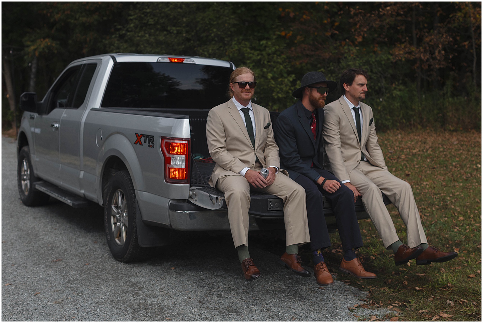 Groomsmen riding in the back of a truck to a campground wedding ceremony in WI